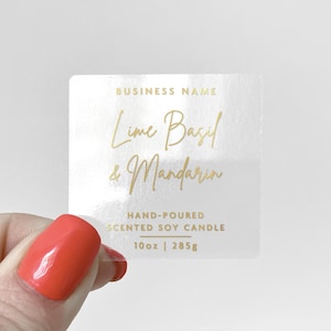 May include: Clear square sticker with gold text. The text reads "BUSINESS NAME", "Lime Basil & Mandarin", "HAND-POURED SCENTED SOY CANDLE", and "10oz | 285g".