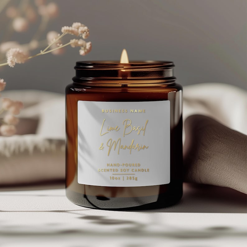 May include: A brown glass candle jar with a white label. The label says "BUSINESS NAME", "Lime Basil & Mandarin", "HAND-POURED", "SCENTED SOY CANDLE", and "10oz | 285g".
