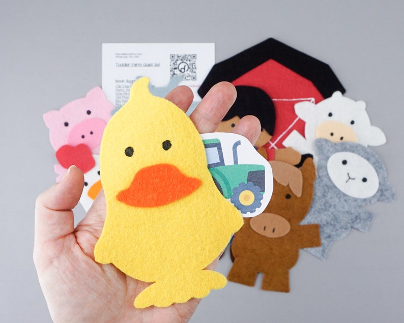 May include: A set of felt farm animal finger puppets, including a yellow duck, a pink pig, a white sheep, a gray lamb, a brown cow, and a red barn. The puppets are designed for children to use for imaginative play.
