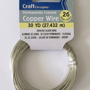 May include: A roll of 30 yards (27.432 meters) of silver-colored copper wire, 26 gauge. The wire is permanently colored and is packaged on a white card with the brand name "Darice" and the product name "Craft Designer™ Permanently Colored Copper Wire".