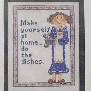 May include: Cross stitch pattern featuring a cartoon woman holding a basket of dishes with the text "Make yourself at home... do the dishes."