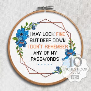 May include: Cross-stitch embroidery in a wooden hoop. The design features the text "I MAY LOOK FINE BUT DEEP DOWN I DON'T REMEMBER ANY OF MY PASSWORDS" surrounded by blue floral accents. The hoop is 10 inches (25 cm) in diameter.