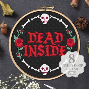 May include: Cross stitch pattern for an 8 inch hoop featuring a black background with the text "DEAD INSIDE" in red, surrounded by white bones, red roses, and skulls.