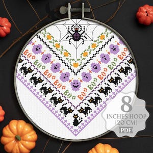 May include: A cross-stitch pattern featuring a spider in a web, ghosts, and bats. The pattern is designed for an 8-inch hoop (20 cm) and is available as a PDF download.