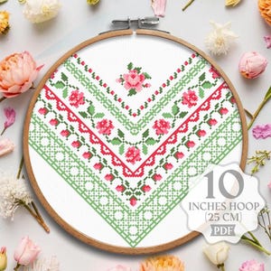 May include: Cross stitch pattern featuring a green and red geometric design with pink roses. The pattern is displayed in a 10 inch (25 cm) embroidery hoop. The pattern is available as a PDF download.