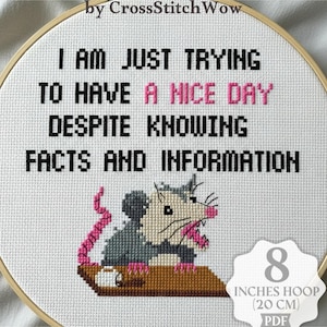 May include: Digital cross stitch pattern featuring the text "I AM JUST TRYING TO HAVE A NICE DAY DESPITE KNOWING FACTS AND INFORMATION". The design includes an opossum. The hoop is 20 cm.