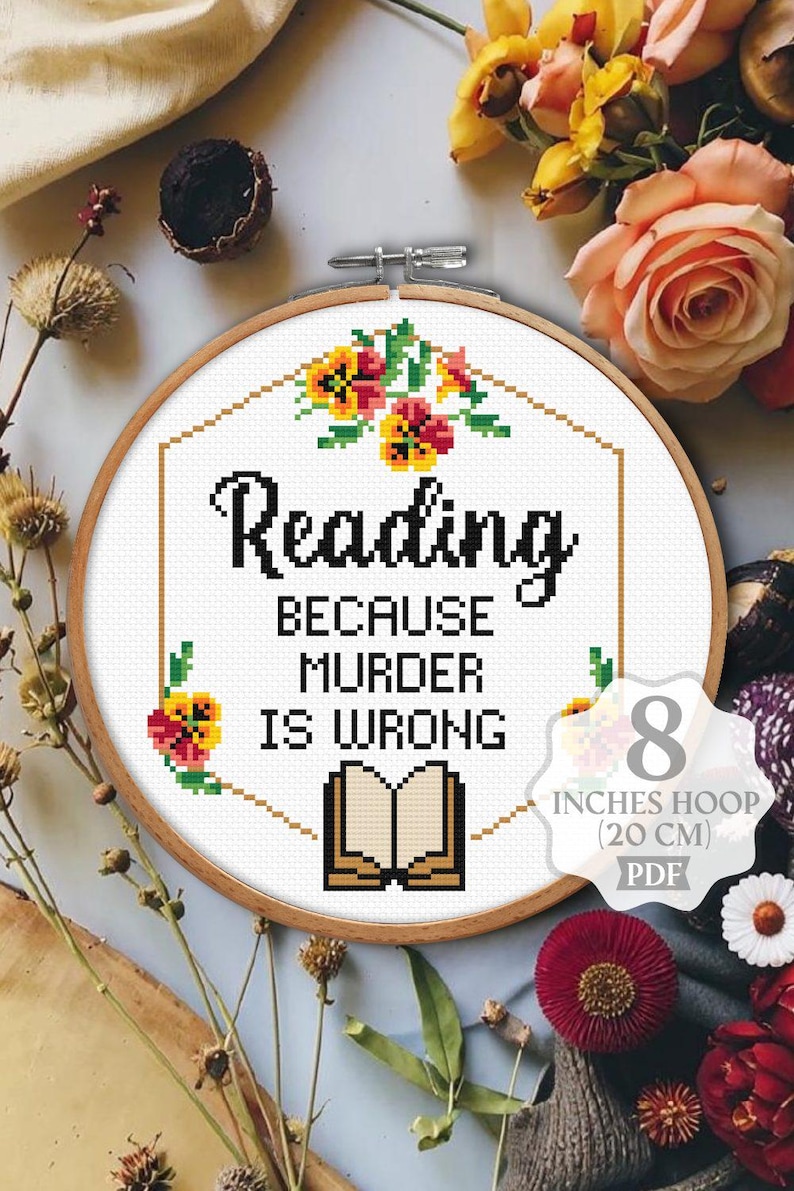 May include: Cross stitch pattern for an 8 inch hoop (20 cm) featuring a book with the text "Reading because murder is wrong". The design includes floral accents in shades of yellow, orange, and red.