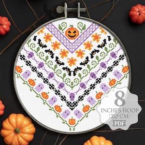 May include: Cross stitch pattern for an 8 inch hoop (20 cm) featuring a Halloween design with pumpkins, bats, ghosts, and stars. The pattern is in a white background with purple, green, black, and orange accents. The pattern is in a PDF format.