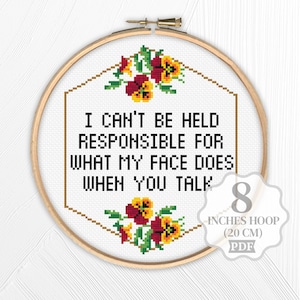 May include: Cross stitch pattern featuring a floral design with yellow and red pansies. The pattern includes the text "I can't be held responsible for what my face does when you talk". The pattern is designed for a 20 cm hoop.