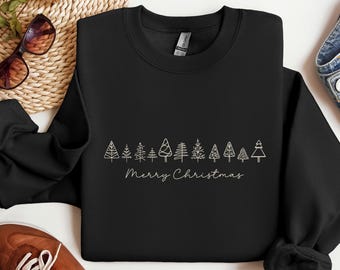 May include: Black crewneck sweatshirt with a line of stylized Christmas trees and the words "Merry Christmas" in a delicate script. The design is in a light color, contrasting against the dark fabric. A festive holiday apparel item.