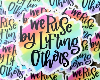 We Rise By Lifting Others -- Rainbow Hand Lettered Weatherproof Vinyl Die Cut Sticker