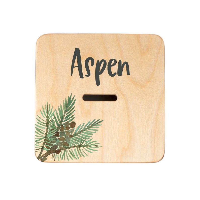 May include: Wooden box with a slot for coins, painted with a pine branch and the word "Aspen".