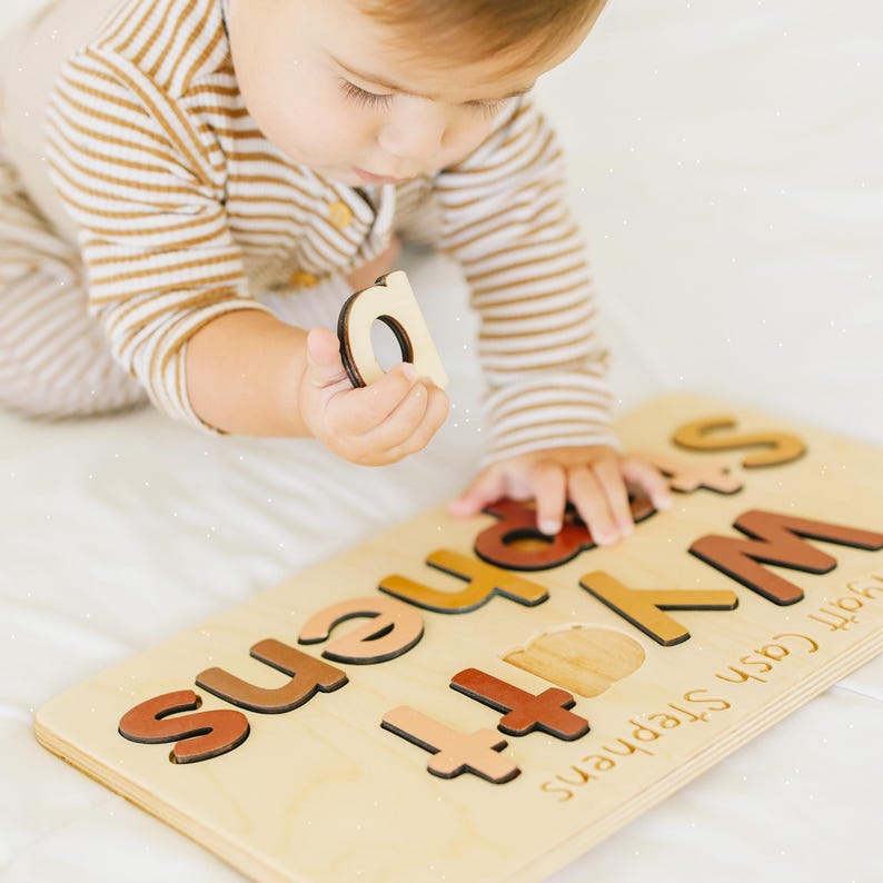 a young child playing with a wooden puzzle