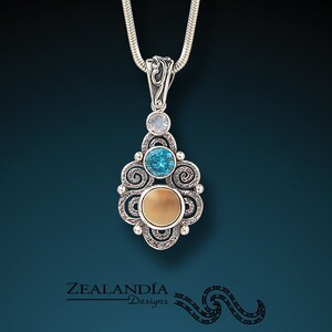 Stardust - Hand Carved Tagua Nut Pendant with Blue Topaz and Rainbow Moonstone