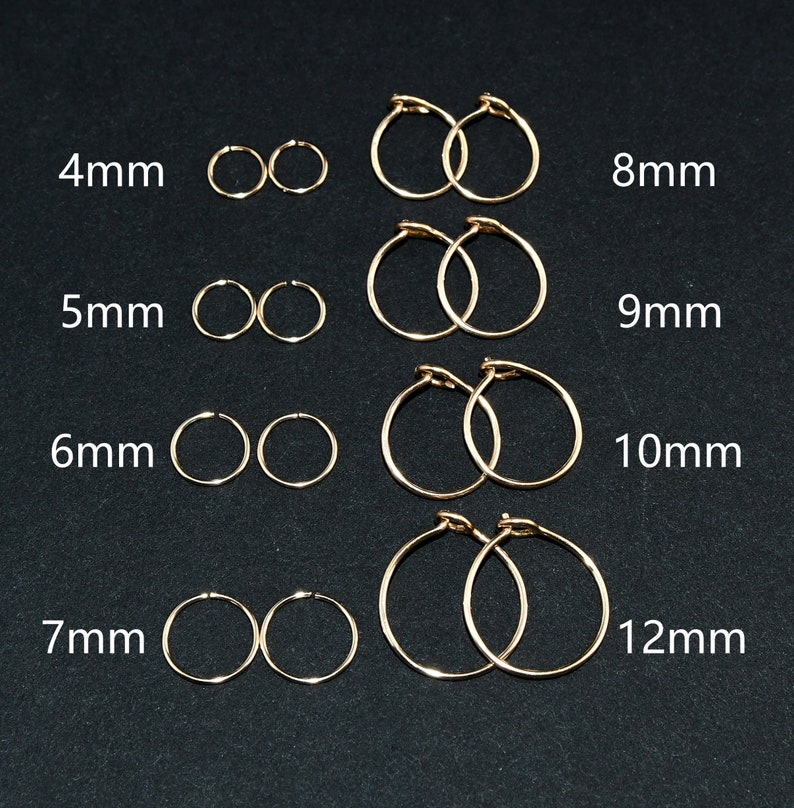 May include: A set of 10 pairs of gold hoop earrings in various sizes, ranging from 4mm to 12mm. The earrings are arranged in rows, with the smallest size at the top and the largest size at the bottom.