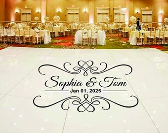 May include: A wedding reception venue with a white dance floor featuring the names "Sophia & Tom" and the date "Jan 01, 2025" in elegant script. Tables are set with white linens and floral centerpieces.
