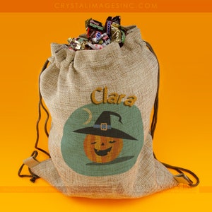 Puede incluir: Una bolsa de yute marrón con el nombre personalizado "Clara" y un diseño de calabaza de Halloween con un sombrero de bruja.