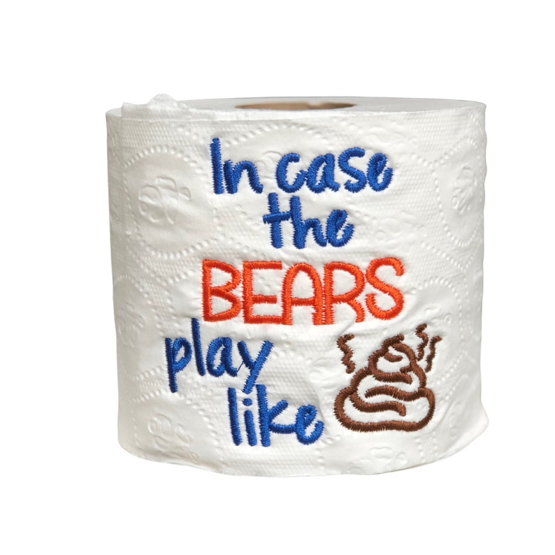 May include: A white toilet paper roll with the text "In case the BEARS play like" embroidered in blue and orange, with a brown poop emoji embroidered next to the text.