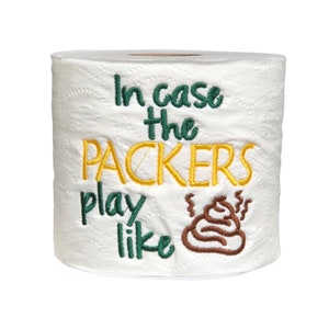 May include: A white toilet paper roll with green and yellow embroidery that reads "In case the Packers play like" and a brown poop emoji.