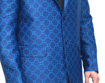 May include: A royal blue blazer featuring a repeating geometric pattern of octagons and squares, a solid blue satin shawl lapel, two front buttons, a chest pocket with a blue pocket square, and two flap pockets, worn over a black button-down shirt.