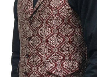 May include: A sleeveless vest featuring a deep red and cream-colored intricate geometric pattern. The garment includes a notched lapel, a front button closure with five dark buttons, and a single visible welt pocket with a flap on the lower left side.