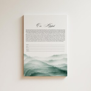 May include: A white ketubah with a green watercolor mountain range design. The text "Our Ketubah" is at the top of the document. The ketubah is a Jewish marriage contract.