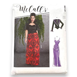 May include: McCall's M8128 sewing pattern envelope featuring a photograph of a garment with a black top and a long red skirt with a black damask pattern. The envelope also displays illustrations of a black jacket and a purple dress with thin straps.