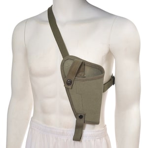 May include: A green canvas shoulder holster for a pistol. The holster has a strap that goes over the shoulder and a flap that covers the gun.