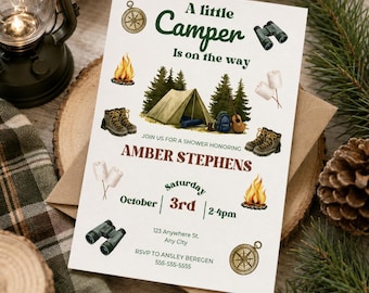 May include: A rectangular baby shower invitation card featuring the text A little Camper is on the way, Amber Stephens, Saturday October 3rd, 2-4pm, 123 Anywhere St. Any City, RSVP to Ansley Beregen 555-555-5555, with illustrations of a tent, campfire, binoculars, compass, hiking boots, and marshmallows.