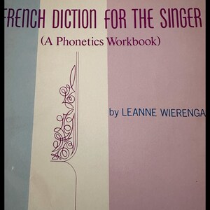 May include: A book cover with the title "FRENCH DICTION FOR THE SINGER" in large, purple letters. The cover also includes the text "(A Phonetics Workbook)" and the author's name, Leanne Wierenga. The background is divided into vertical sections of light blue, white, and pink.