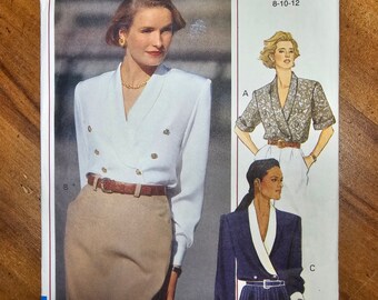 May include: A sewing pattern for a women's blouse and skirt. The pattern is for sizes 8-10-12. The pattern is from Vogue Classics and has the number 7974.