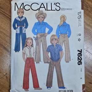 May include: McCall's sewing pattern envelope featuring illustrations of children's Western-style outfits. The envelope includes images of a cowboy shirt, pants, and a jumpsuit. The text "McCall's" and pattern number 7626 are visible.