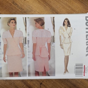 May include: Butterick sewing pattern 6060 showing a two-piece suit with a double-breasted jacket and a pencil skirt. The pattern includes illustrations of the suit in a light pink colour with a white lace detail.