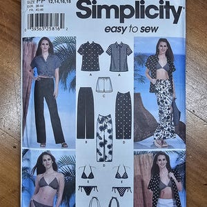 May include: A Simplicity sewing pattern, number 7231, featuring various clothing designs. The cover displays images of a woman wearing different outfits, including shirts, shorts, pants, and swimwear. The text "Simplicity easy to sew" is prominently displayed.