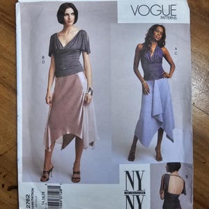 May include: Vogue Patterns 2762 sewing pattern envelope featuring illustrations of two outfits. One shows a dark gray cowl-neck top with cut-out sleeves and a light pink skirt. The other shows a purple halter top and a light blue asymmetrical skirt.