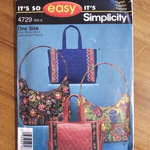 May include: A Simplicity sewing pattern envelope 4729 for bags, featuring text IT'S SO easy IT'S Simplicity. The cover displays four bag designs: a blue quilted tote, a red quilted tote, a black floral hobo bag, and a yellow owl print hobo bag.