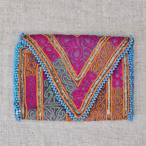 This gorgeous vintage Afghan tribal wallet is a unique mix of traditional embroidery, braid and beading with a 1960&#39;s mod floral lining.