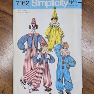 May include: Vintage Simplicity sewing pattern 7162 for boys' and girls' clown costumes. The pattern features illustrations of four different clown outfits in various colors, including red, blue, and yellow. The pattern size is for sizes 6-8.