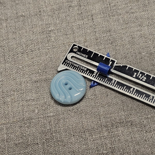 Vintage glass button. Round, pale blue, textured, sew through, 11/16"(1.3cm)  by 8th inch"