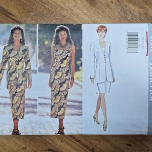 May include: A vintage Butterick sewing pattern featuring a woman in a long-sleeved jacket and matching dress with a black and gold floral design. The pattern also shows a white suit with a skirt. The pattern number is 4001.