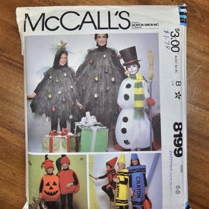 May include: A McCall's sewing pattern envelope, number 8199, for children's costumes. The cover displays illustrations of costumes including a Christmas tree, a snowman, a pumpkin, and three crayon outfits in red, yellow, and blue.