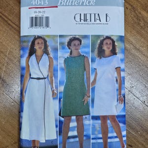 May include: A Butterick sewing pattern envelope featuring three dress designs. The envelope is labeled "4043" and includes the size range "18-20-22". The designs include a white wrap dress, a green sheath dress, and a white shift dress.