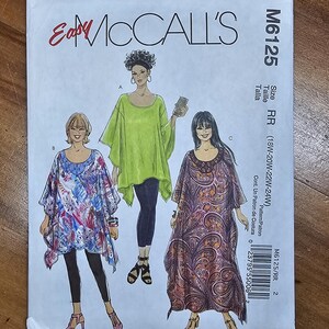 May include: McCall's M6125 sewing pattern featuring three different tunic designs. The pattern includes sizes RR (18W-24W). The cover shows illustrations of the tunics in various colors and patterns, including floral and paisley.
