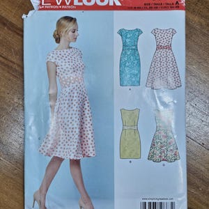 May include: A New Look sewing pattern, S0863, featuring illustrations of four different dresses. The pattern includes a dress with a polka dot design, a floral print dress, and two other dress styles. The model in the image is wearing a polka dot dress.