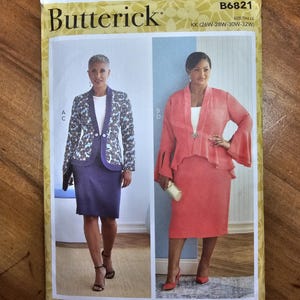 May include: Butterick sewing pattern B6821 featuring two women's suits. One suit is a blue and white patterned jacket with a purple skirt. The other is a coral-colored jacket and skirt. The pattern size is KK (26W-28W-30W-32W).