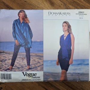 May include: A vintage Vogue Patterns sewing pattern featuring designs by Donna Karan. The pattern cover shows two women modeling clothing. The pattern number is 2667, and the size range is 6-10. The words "American Designer" are printed on the cover.