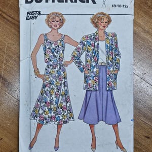 May include: A vintage Butterick sewing pattern featuring illustrations of two outfits: a floral print dress and a matching jacket and skirt ensemble. The pattern includes the text "FAST & EASY" and the pattern number 3823.