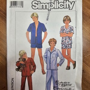 May include: Simplicity sewing pattern 7078 for children's pajamas. The package features illustrations of boys in various pajama styles, including shorts sets and long pants sets. The text "E-A-S-Y TO SEW" is visible.
