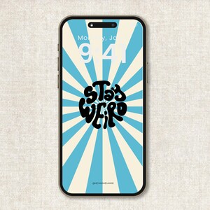 May include: A smartphone displays a retro-style wallpaper with a blue and cream sunburst design. The words "Stay Weird" are in a black, bubble-style font. The time is 9:41. The @heyannemarie watermark is at the bottom.