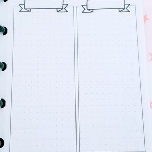 May include: A printable planner page with two columns for listing tasks or goals. Each column has a banner at the top with space to write a title. The page has a dotted grid pattern and a black arrow with hearts at the bottom.